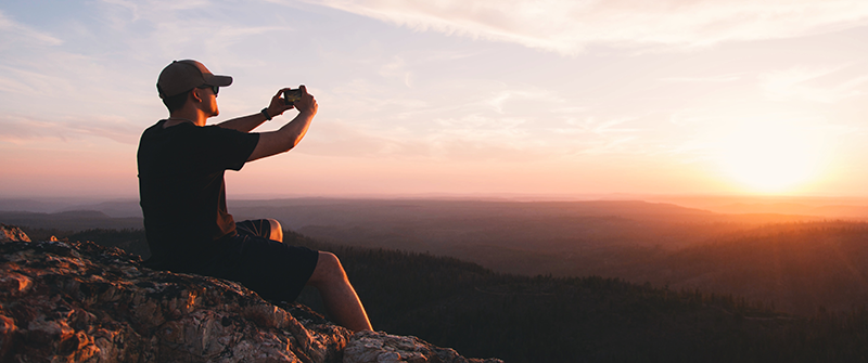 A person taking a great picture of a sunrise